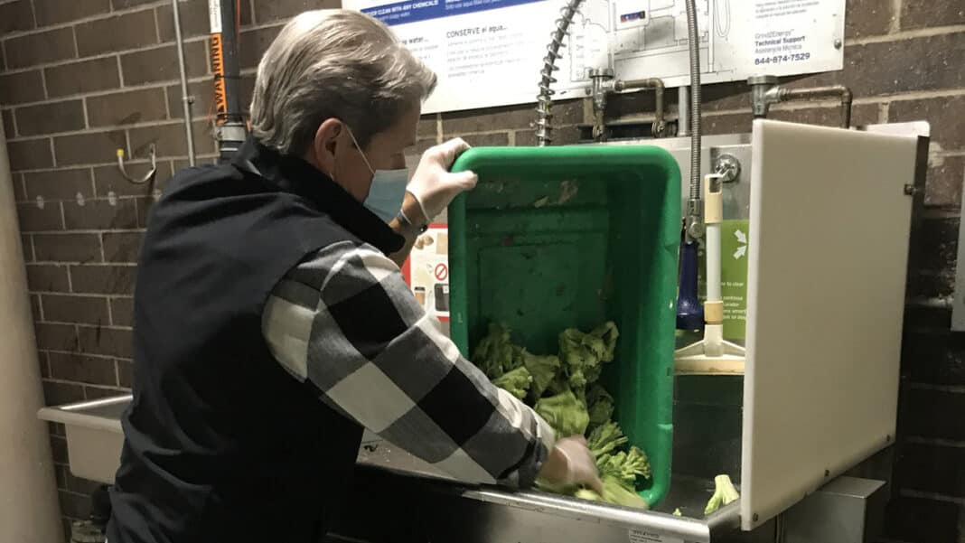 IMG_6024-1 David Sorensen, deli manager at Sendik’s in Franklin, loads food waste into the store’s Grind2Energy system.