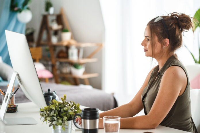 Woman using computer at home office
